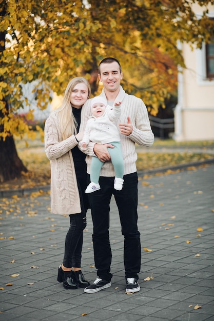 Portrait of lovely young family sitting together outside