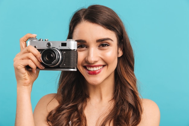 Portrait of a lovely young woman holding photo camera