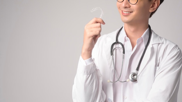 Portrait of male confident doctor over white background studio