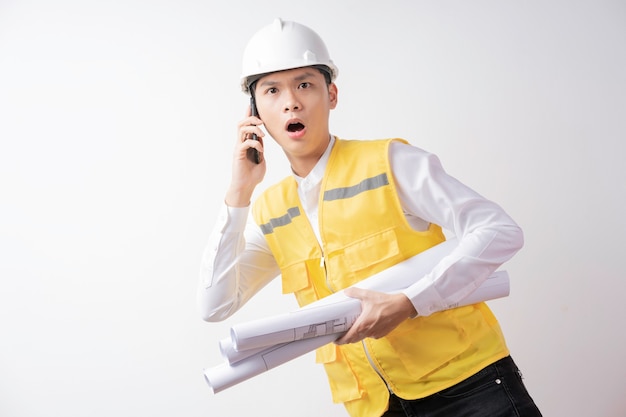 Portrait of male construction engineer with expression on white background