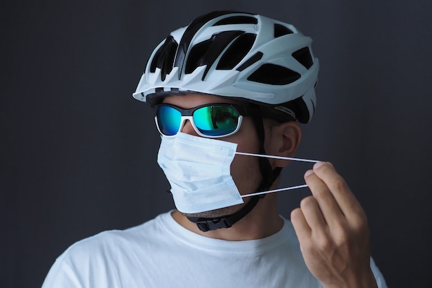 Portrait of a male cyclist in a medical mask. Covid-19 concept