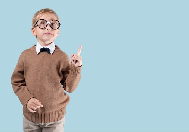 Portrait of male elementary school student with lightbulb picture on blackboard