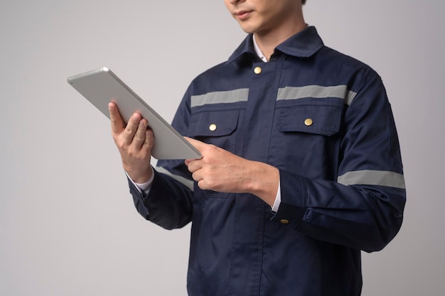 Portrait of male engineer wearing a protective helmet over white background studio