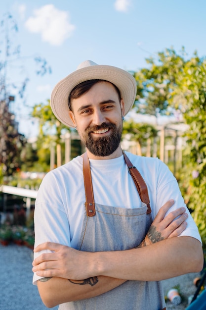 Portrait of male florist in flower shop owner of garden centre looking to camera high quality photo