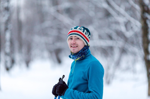 Portrait of male skier in forest at winter