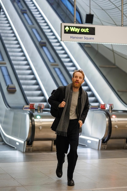 Portrait of male tourist with a backpack walking along the terminal of airport