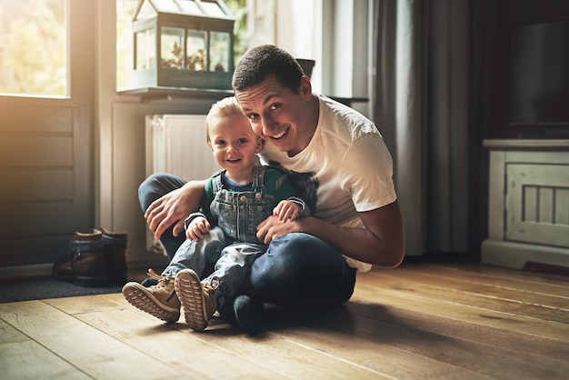 Portrait man and child in living room for love family and happiness in home together Dad young boy and smile for relationship care and play for development and fun in lounge for bonding or relax