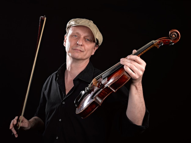 Portrait of a man holding a  wooden violin