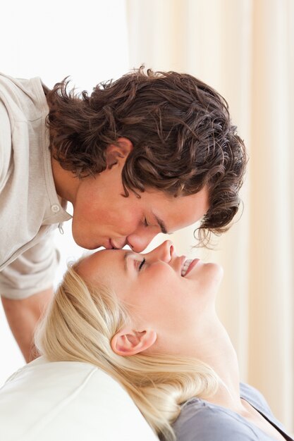 Portrait of a man kissing his fiance on the forehead