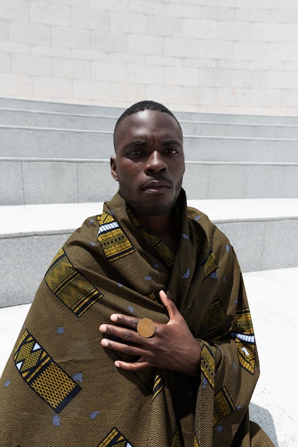 Portrait of man outdoors in traditional african attire