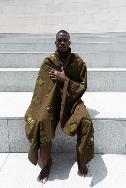 Portrait of man outdoors in traditional african attire