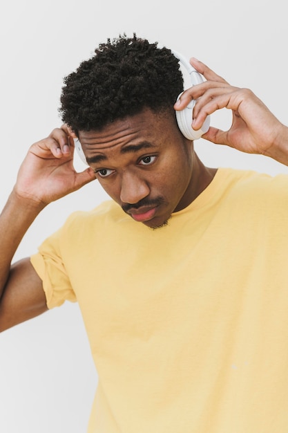 Portrait of man putting on headphones