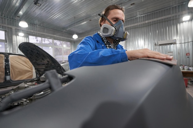 Portrait of man in respirator hard working in workshop