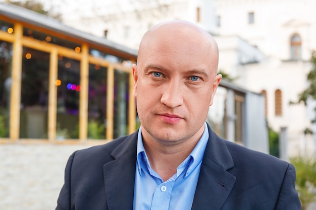 portrait of a man in a shirt on a businessman street background