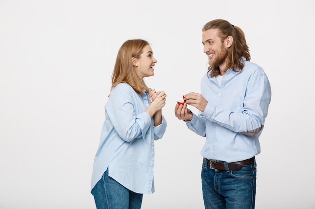 Portrait of man showing an engagement ring diamond to his beautiful girlfriend 