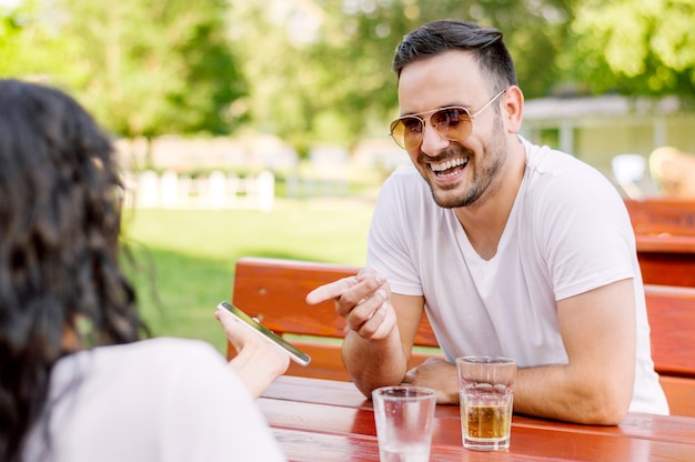 Portrait of a man sitting with his girlfriend in cafe