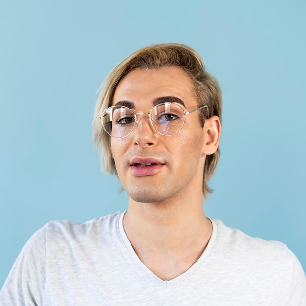 Portrait of man wearing reading glasses and make-up