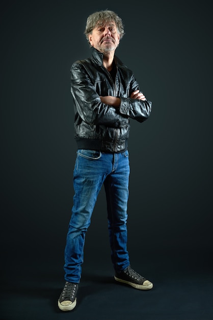 Portrait of a man with leather jacket and denim pant