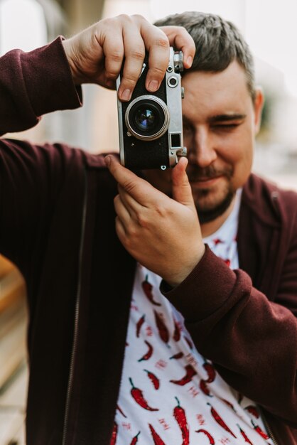 Portrait of a man with a retro camera