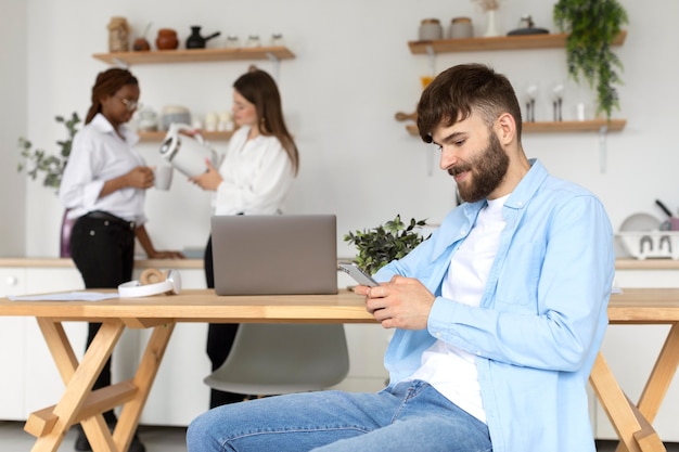 Portrait of man working next to his colleagues