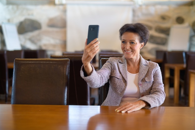 Portrait of mature beautiful businesswoman at the coffee shop