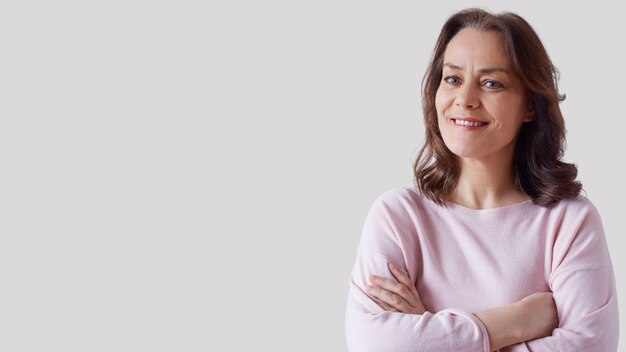 Portrait of a mature, beautiful woman in a pink tunic