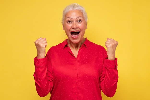 Portrait of a mature italian woman doing a winner gesture