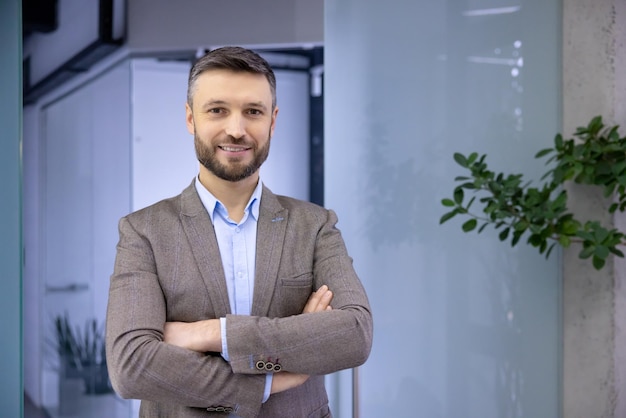 Portrait of mature successful businessman in business suit inside office experienced satisfied man