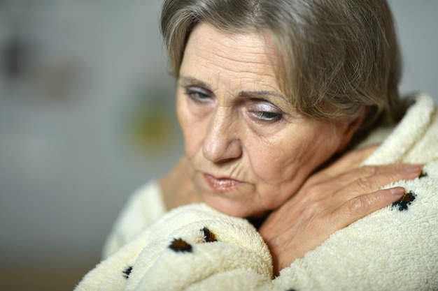 Portrait of mature woman fells ill at home