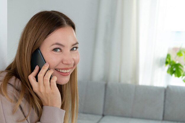 Portrait of mature woman using a mobile phone. Middle-aged female. Beautiful smiling lady.