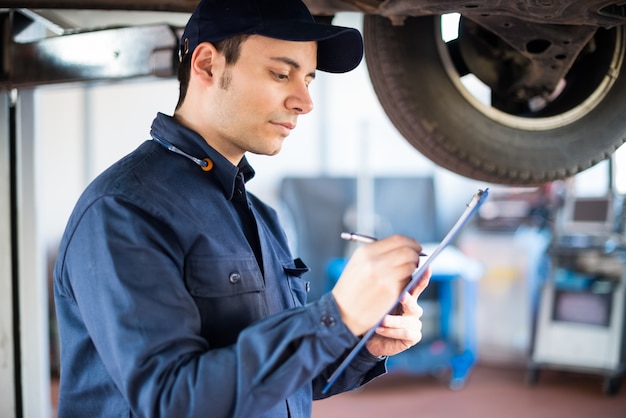 Portrait of a mechanic at work in his garage