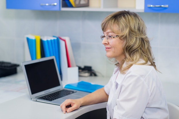 Portrait of medical expert at work using laptop