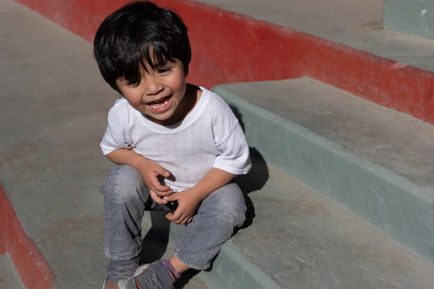 Portrait of a Mexican boy laughing sunny day children rights