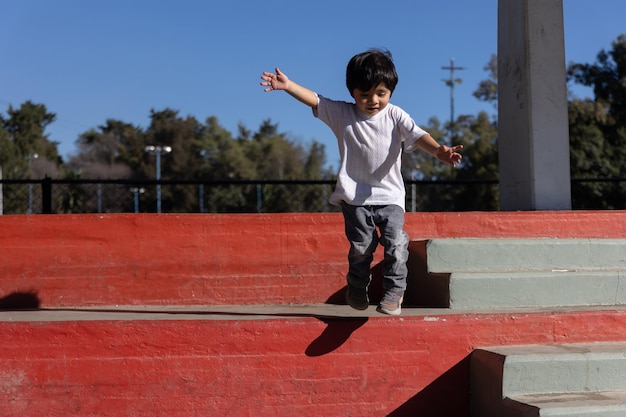 Portrait of a Mexican boy on red stairs