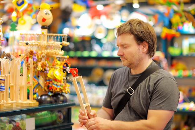 Portrait of middle age man at shop of wooden toys