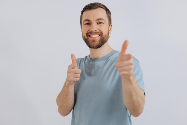 Portrait of a modern bearded middleaged man in a blue tshirt showing good emotions on a white background