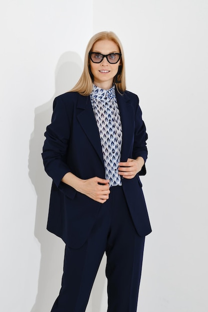 Photo portrait of a modern confident woman in a navy blue classic fitted suit