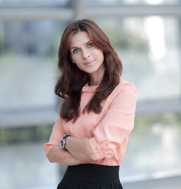 Portrait of modern young woman on blurred office background