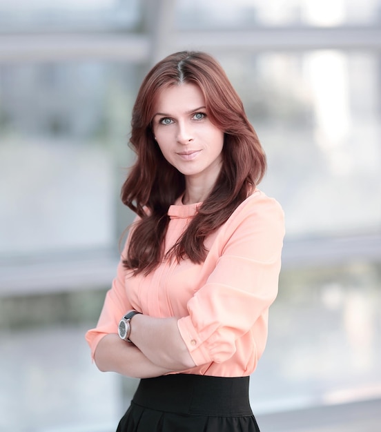 Portrait of modern young woman on blurred office background