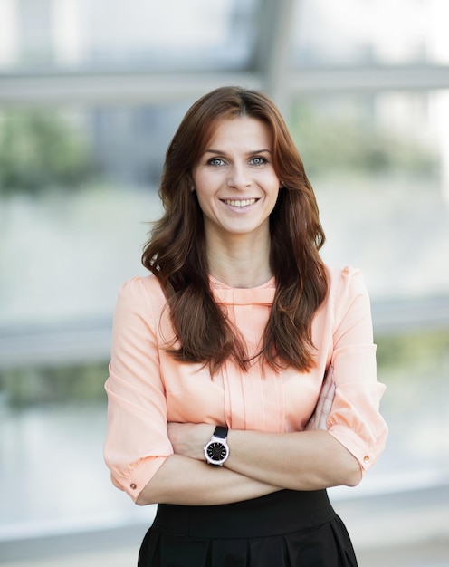 Portrait of modern young woman on blurred office background