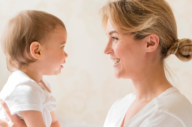 Portrait of mom and baby looking at each other