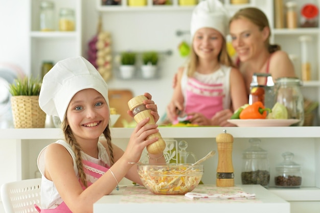 Portrait of mom and daughter cook to eat