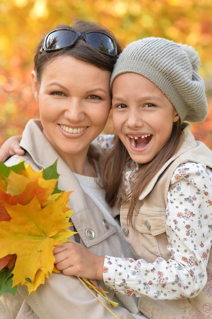 Portrait of a mother and daughter hugging outdoors