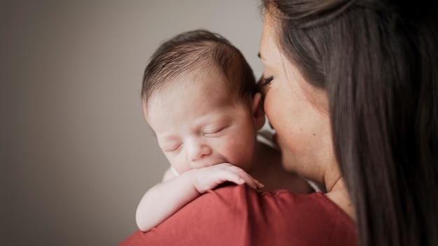 Portrait of mother holding little baby