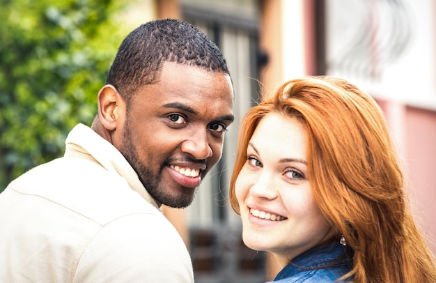 Portrait of multiethnic man and young woman walking outdoors