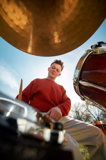 Portrait of musician playing percussion instrument for world music day