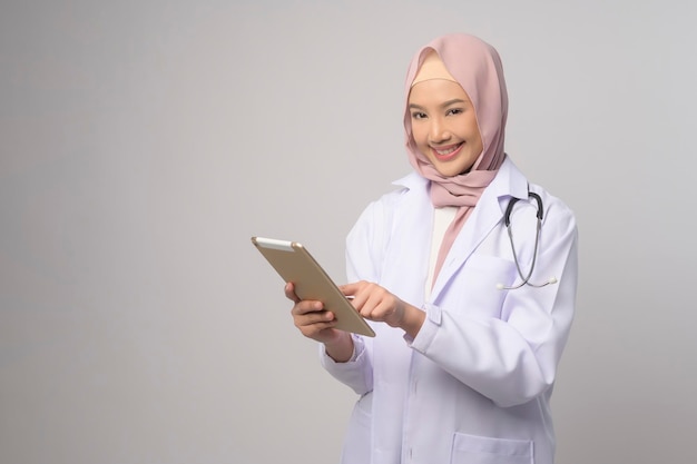 Portrait of muslim female confident doctor over white background studio