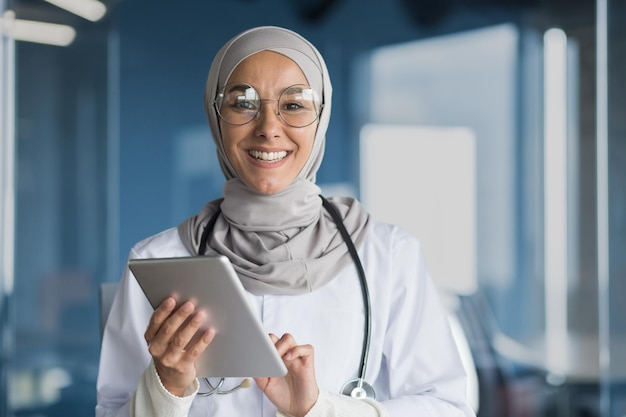 Portrait of a muslim female doctor in a hijab with a tablet in her hands the doctor works in the