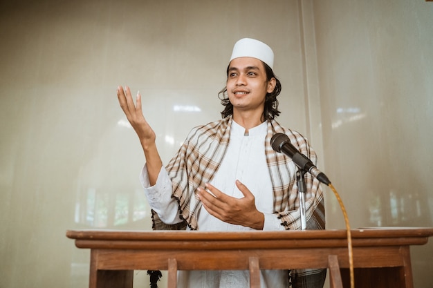 Portrait of muslim male preacher sharing about islam during prayer time in the mosque