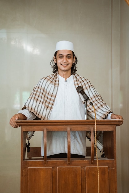 Portrait of muslim male preacher sharing about islam during prayer time in the mosque